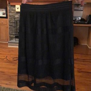 Black sheer over shorter black slip.